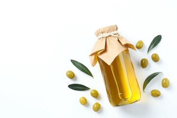 Bottle of fresh olive oil and olives with leaves on white background