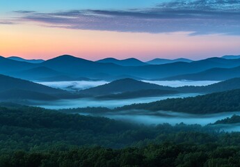 Obraz premium Serene sunrise over misty mountain range.