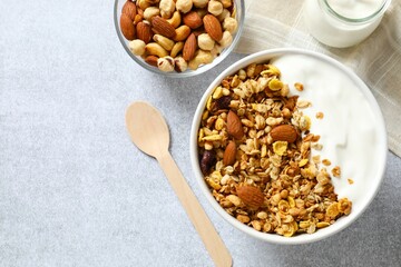Delicious granola with yogurt on a gray background