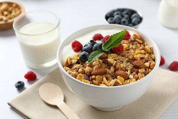 Delicious granola with berries and yogurt on a light background
