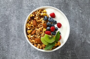 Delicious granola with berries and yogurt on a light background