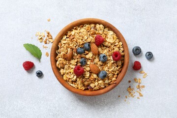 Delicious granola with berries on a light background