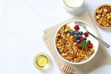 Delicious granola with berries and yogurt on a light background