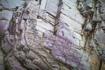 Surface texture and multicolored by nature of coastal rock layers