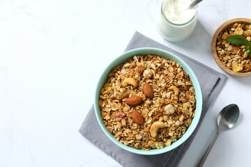 Delicious granola with berries and yogurt on a light background