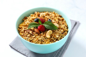 Delicious granola with berries and yogurt on a light background