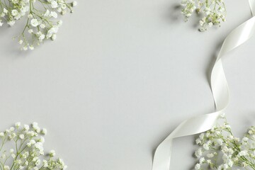 Top view photo with gypsophila flowers on gray background 