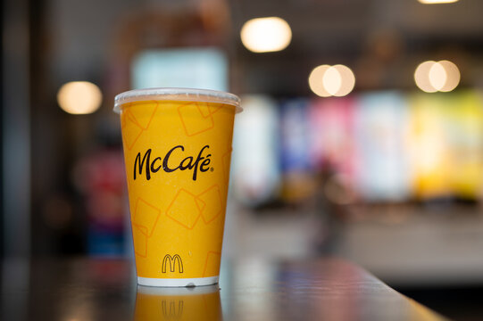 Ho Chi Minh, Vietnam - August 24, 2024: close up shot of a McCafe cup placed on a table in a McDonald's fast-food restaurant.