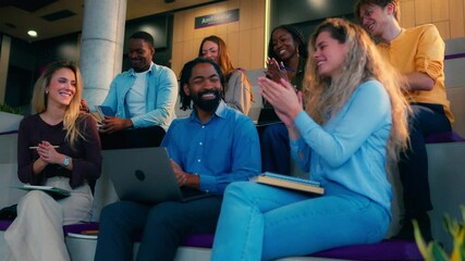 Professional business team celebrating successful presentation, showing collaborative spirit and shared excitement in modern office environment with diverse colleagues applauding