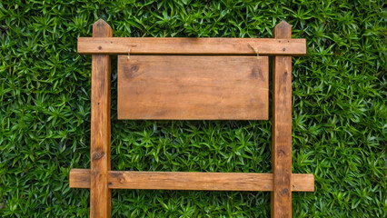 Fototapeta premium A wooden blank plate is located on a green nature background. Natural wood textures emphasize ecology and harmony with the environment.