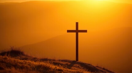 Silhouette of a cross at sunset, atop a hill overlooking a hazy landscape. A serene and peaceful image evoking contemplation and hope.