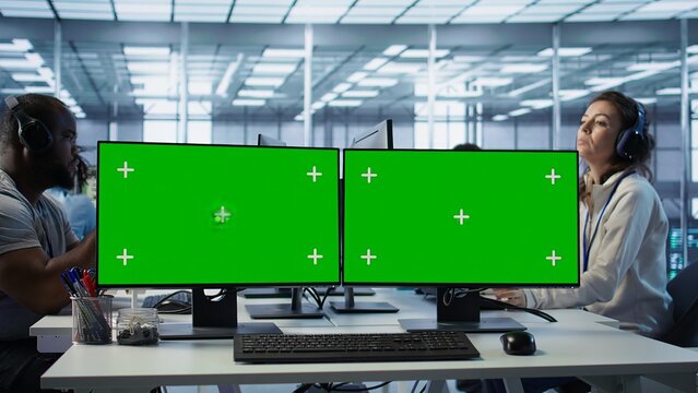 Green screen PC multi monitor setup in server hub workspace used to repair devices storing datasets. Chroma key computer used for servicing rigs doing computational operations, camera B