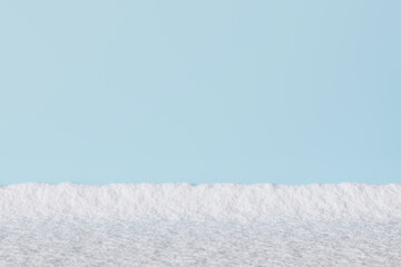 Clean snowy foreground with a bright blue sky backdrop. Minimalistic winter landscape perfect for seasonal designs, holiday themes, or serene natural compositions. Copy space for text. 3D rendering.