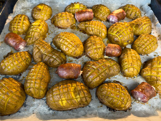 Baked potatoes in the skin with sausage. Potatoes cut in half and the top cut into small cubes. Final baking as a little hedgehog.