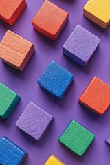 Colorful wooden building blocks on a purple background