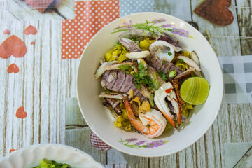 A bowl of special food of dry egg yellow noodle with crawfish, shrimp and crab, sold in Chanthaburi province, Thailand