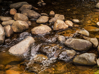 Water Gushing Between Rock Piles
