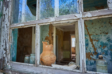 Broken Pot and Bottles on Window Sill