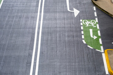 A detailed view of urban road markings alongside a designated cycle lane, highlighting the importance of sustainable transportation and urban planning in modern cities.