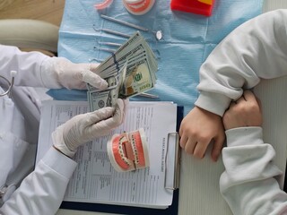 The patient consults with the doctor about the cost of dental braces dental treatment and payment...