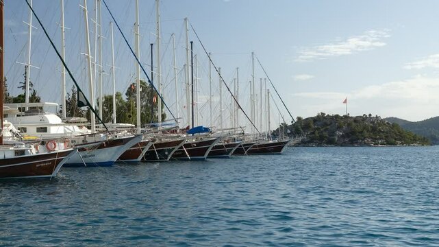 Gulets and Green island in the holiday town of Bozburun. Mediterranean village in Turkey. Marmaris district, Mugla province, Turkey country
