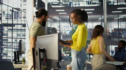 Computer scientist working, doing software debugging using notebook, troubleshooting errors. Woman standing in office, fixing coding issues using laptop, solving tasks, camera B