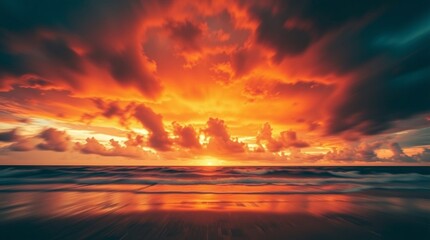 Obraz premium Fiery Sunset Seascape: A breathtaking panoramic view of a fiery sunset over the ocean, where intense orange and red hues paint the sky and reflect on the calm waves.