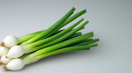 Bunch of green onions are displayed on a white background. The onions are fresh and ready to be used in a meal