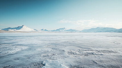 Cold, windswept icy expanse with distant snow-capped peaks
