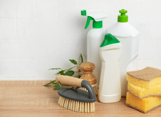 Cleaning products and brushes eco friendly arranged on wooden tabletop