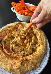Sweet potato hummus or pumpkin dip with smoked paprika, olive oil, whole chickpeas close up. Healthy vegan food. 