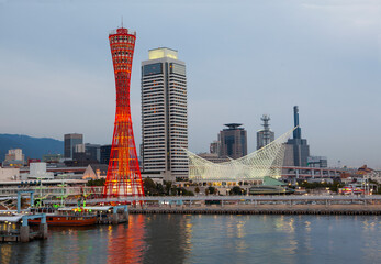 Kobe Port tower and maritime museum in the port of Kobe illuminated at dusk