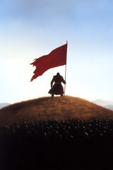 A Mongol warlord standing atop a hill, his banner held high as his army thunders past him into battle.