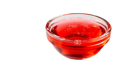 A small glass bowl filled with red liquid. The bowl is placed on a white background
