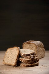 Sliced whole grain bread on wooden table.