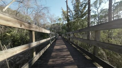 Drone shot along wooden path at Mattie Kelly Park and Nature Walk in Destin