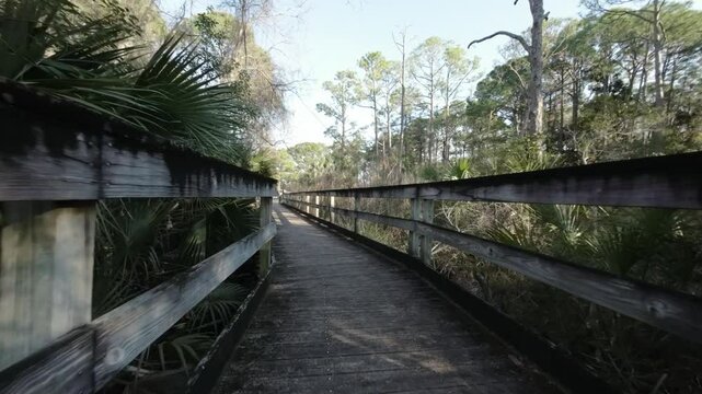 Drone shot along wooden path at Mattie Kelly Park and Nature Walk in Destin