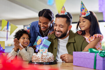 Happy multiethnic family celebrating father's birthday at home