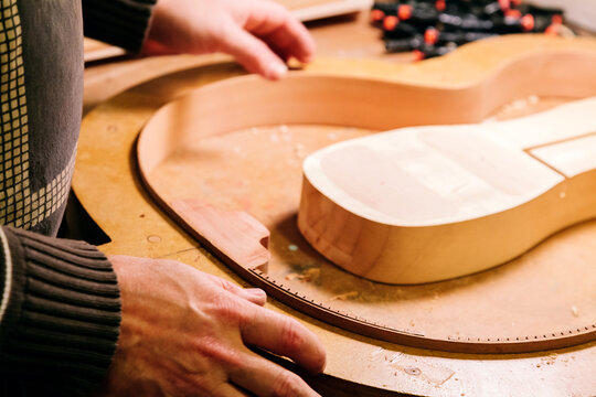 Crafting a bass guitar in a luthier workshop's creative process