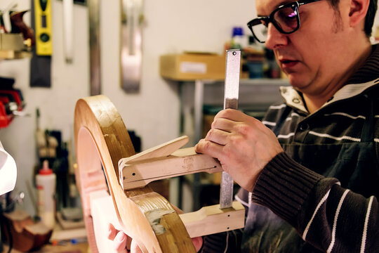 Crafting a bass guitar in a professional luthier workshop