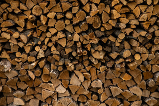 Stacked firewood creating a textured rustic background
