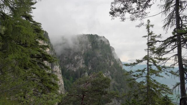Clouds move around Mount Penegal, Mendelpass, Trentino - South Tyrol, Italy on an overcast day