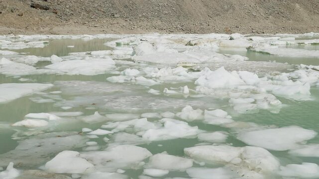 A serene glacial lake with floating ice at Mount Edith Cavell, Canadian Rockies