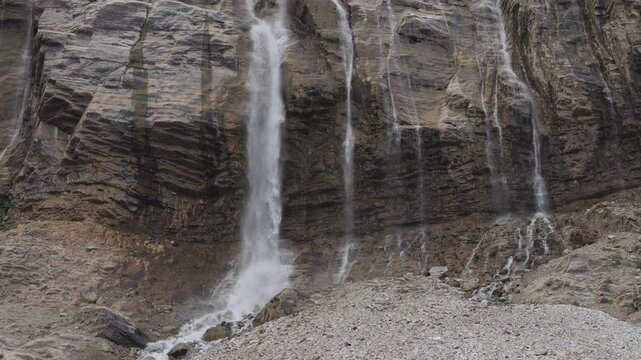 A stunning waterfall flows down rocky cliffs in Mount Edith Cavell, Canadian Rockies