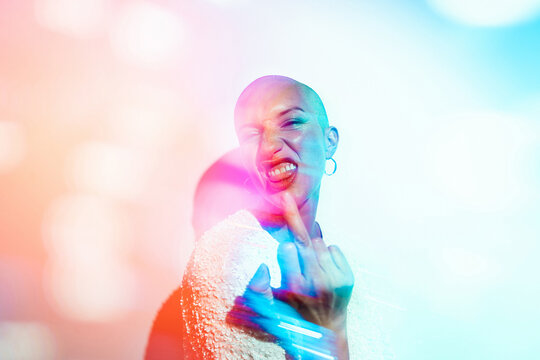 Woman doing a expressive defiance gesture with finger towards camera