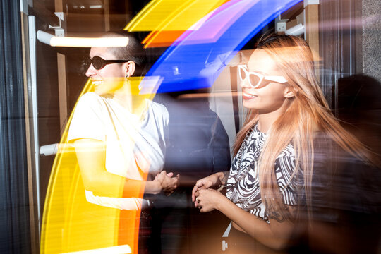 Vibrant night out with a joyful lesbian couple, motion blur effect