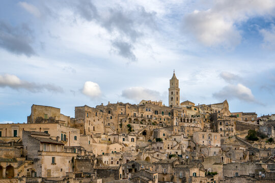 Historic Matera Cityscape with Cathedral Under Cloudy Sky