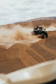 Off-road vehicle driving through Lanzarote's rugged terrain