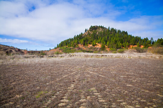 Scenic view of El Tanque with volcanic landscape and blue sky
