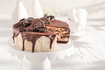 Sweet Cookie cheesecake with chocolate glaze on white.